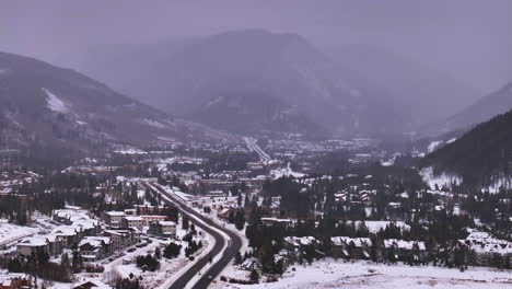 Cinematic-Colorado-aerial-drone-winter-December-Christmas-road-to-downtown-Keystone-Ski-Resort-Epic-Local-Pass-entrance-Rocky-Mountains-i70-Breckenridge-Vail-Summit-County-High-Country-living-backward