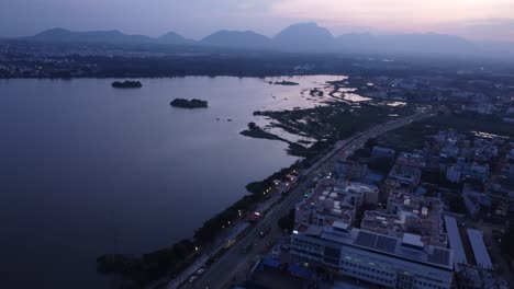 Epic-aerial-view-of-Noyyal-River-Ukkadam-Periyakulam-Park,-Coimbatore-city-view-at-night,-Tamil-Nadu,-India