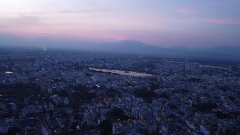 Panoramic-aerial-view-of-Coimbatore-city-under-hazy-sky-at-sunset,-Tamil-Nadu,-India