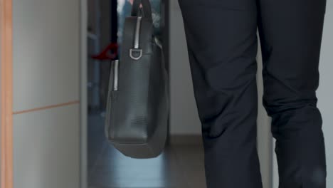 Slow-motion-shot-of-a-business-man-walking-holding-a-briefcase-for-a-meeting