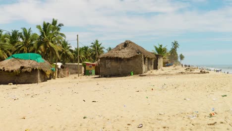 Wide-view-of-primitive-buildings-on-sand-beach-in-Moree-village,-Ghana
