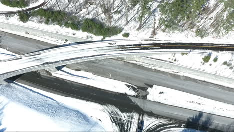 Drone-shot-of-snow-covered-road-or-highway