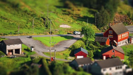 A-small-grey-car-drives-through-the-village-on-the-coast-of-the-Hardanger-fjord
