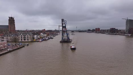 Matador-crane-towers-over-the-water-and-the-small-tug-boat-below