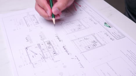 Architect-checking-house-construction-blueprint-plans