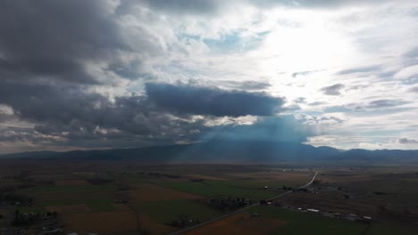 Drone-shot-of-a-stormy-looking-sky-with-the-sunlight-coming-through-in-rays