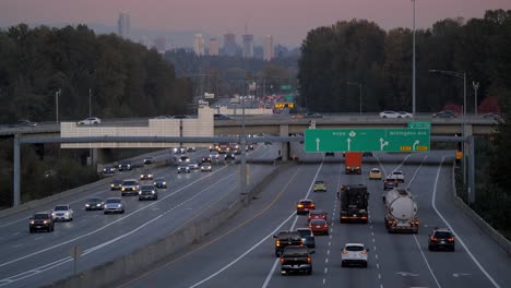 Static-Shot-Traffic-on-Canadian-Highway-1-with-City-Background-at-Dusk