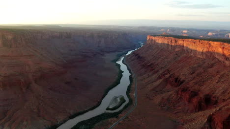 Aerial-cinematic-drone-Colorado-river-Moab-Utah-dramatic-orange-sunset-mountain-Big-Enchilada-landscape-Arches-National-Park-Castle-Valley-Castleton-Fishers-Tower-camping-slowly-forward