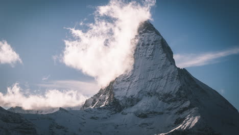 Timelapse-first-snow-sunny-bluebird-steam-fog-the-stunning-Matterhorn-Zermatt-Switzerland-cinematic-wintery-opening-scene-Swiss-Alps-Toblerone-Interlocken-most-famous-mountain-peak-early-October