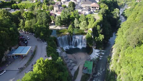 Aerial-establishing-shot-of-beautiful-Pliva-Waterfall-in-Jajce