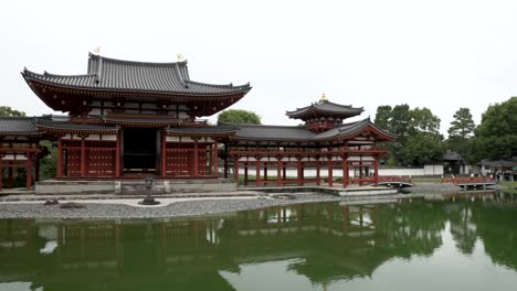 Byodo-in-buddhist-Temple-near-water-pond-pan-left-shot-in-Kyoto-Japan