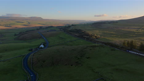 Establishing-Drone-Shot-of-Yorkshire-Dales-Landscape-and-Passenger-Train
