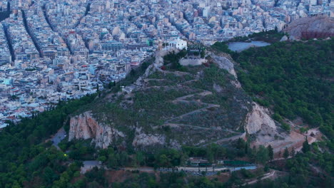 Tight-aerial-shot-towards-the-tallest-hill-in-Athens