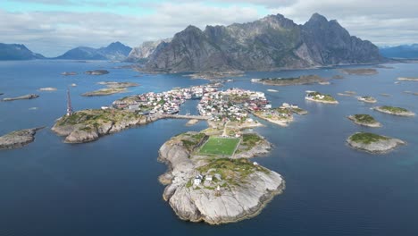 Henningsvaer-Village-and-Soccer-Field-in-Lofoten-Island-Archipelago,-Norway---4k-Aerial-Circling