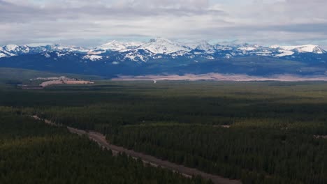Drone-aerial-view-of-highway-leading-into-the-mountains-in-Montana
