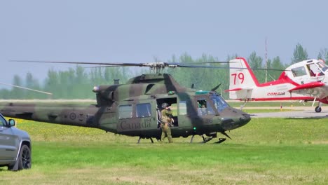 Close-shot-of-a-helicopter-on-the-ground-and-a-Canadian-soldier