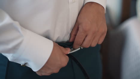 Detail-of-Man-Fastening-a-Belt
