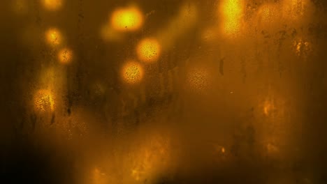 Yellow-bokeh-background-animation-seen-through-a-watery-and-unclean-glass