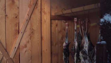 Closeup-Of-Roe-Deer-Meat-Hanging-Inside-Smokehouse-Shed-In-Norway