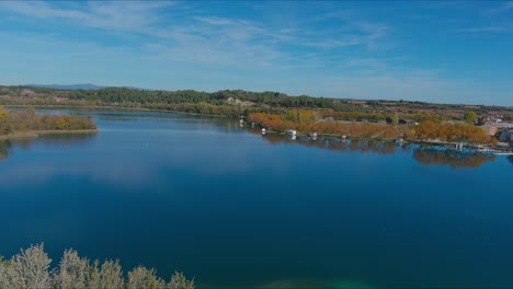 Drone-flying-over-Lake-Banyoles-in-autumn-season