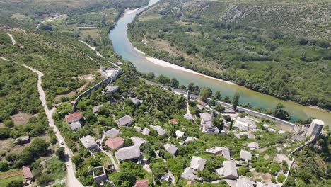 Drone-flyover-Historic-village-of-Pocitelj-by-Neretva-river,-Bosnia-and-Herzegovina