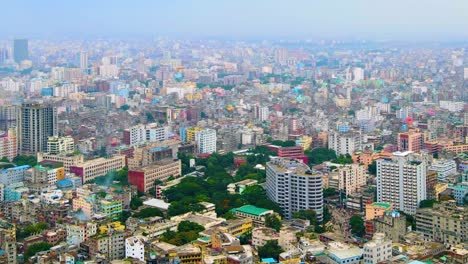 Megacity-of-Dhaka-with-green-parks-in-middle,-aerial-drone-view