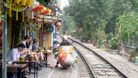 People-sit-awaiting-unusual-sight-trains-passing-through-residential-area