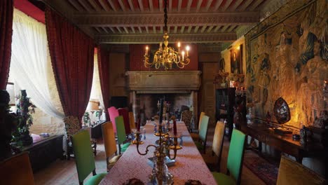 Dining-room-of-chateau-for-elaborate-meals,-featuring-large-dining-table,-opulent-decor,-and-chandelier