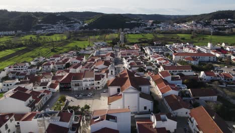 Aerial-view-of-traditional-village-of-Aljezur-in-Portugal,-orbiting-cityscape