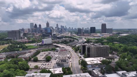 Cinematic-aerial-view-of-modern-Atlanta-cityscape,-street-traffic,-Peachtree-Street-famous-skyline-buildings,-Georgia,-USA