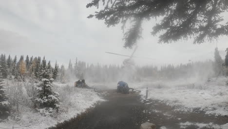 Bell-helicopter-landing-in-a-snowy-wilderness-backcountry,-very-strong-prop-wash,-ground-crew-crouching-next-to-landing-helicopter