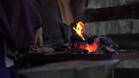 Blacksmith-Heating-Iron-in-the-Forge,-Shaping-and-Forming-it-with-a-Hammer,-Skilled-Craftsman-for-Traditional-Handcrafted-Tools