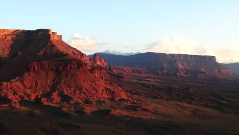 Aerial-cinematic-drone-Moab-Utah-dramatic-orange-red-sunset-mountain-snow-peak-Big-Enchilada-landscape-Arches-National-Park-Castle-Valley-Castleton-Fishers-Tower-camping-Colorado-river-slowly-upward