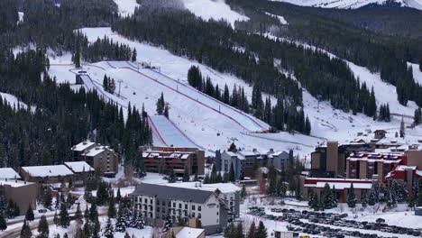 Parking-Lot-Half-Pipe-Big-Air-Jump-ski-snowboard-gondola-ski-lift-aerial-drone-cinematic-Copper-Mountain-base-Colorado-Winter-December-Christmas-Ski-runs-trails-landscape-Rocky-Mountains-circle-right