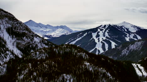 Distant-Copper-Mountain-Colorado-Winter-December-Christmas-aerial-drone-cinematic-landscape-i70-Leadville-Silverthorne-Vail-Aspen-Ten-Mile-Range-cloudy-Rocky-Mountains-upward-reveal