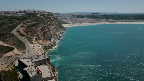Drone-shot-of-Nazaré-lighthouse-and-city-view-at-distance