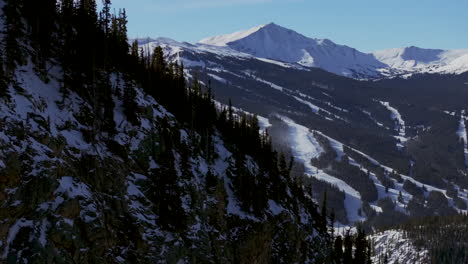 Ski-run-half-pipe-Copper-Mountain-Colorado-Winter-December-Christmas-aerial-drone-cinematic-landscape-i70-Leadville-Silverthorne-Vail-Aspen-Ten-Mile-Range-blue-sky-clouds-Rocky-Mountains-right-reveal