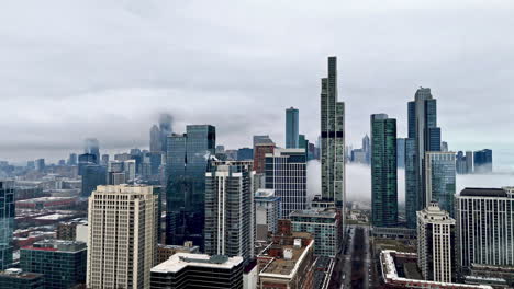Aerial-circling-shot-of-skyscrapers-in-the-South-Loop,-foggy-day-in-Chicago,-USA