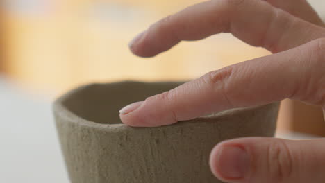 Dexterous-fingers-sculpt-a-clay-cup's-delicate-form,-close-up-glimpse-into-an-artisan's-magical-creation