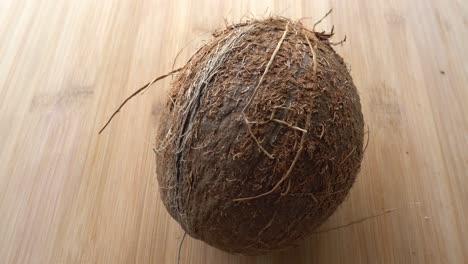 Coconut-close-up-on-Wooden-background-isolated-4K