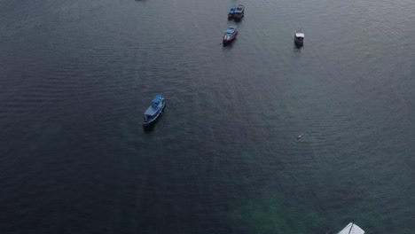 Aerial-drone-shot-of-the-dive-boats-in-harbor-at-sunset-in-Koh-Tao-Thailand-in-southeast-Asia