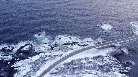 Winter-surrounds-Djupfjordbrua-bridge,-rhythmic-ripples-on-ocean-surface