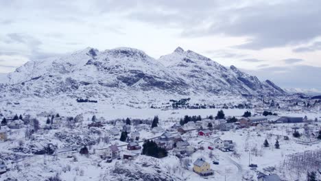 Like-scene-from-Christmas-card,-Nordic-village-with-mountain-backdrop