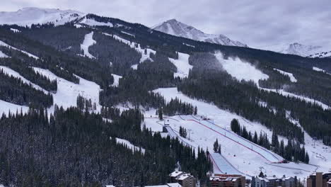 Snow-making-Half-Pipe-Big-Air-Jump-ski-snowboard-gondola-ski-lift-aerial-drone-cinematic-Copper-Mountain-base-Colorado-Winter-December-Christmas-Ski-runs-trails-landscape-Rocky-Mountains-circle-left