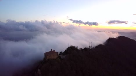 Drone-flying-over-clouds-and-mountains-in-Spain