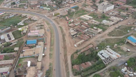 Traffic-on-main-road-in-Loitokitok-village,-Kenya,-Africa,-aerial-time-lapse