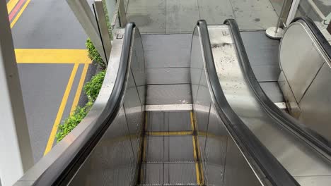 Point-of-View-of-a-outdoor-empty-escalator-going-down
