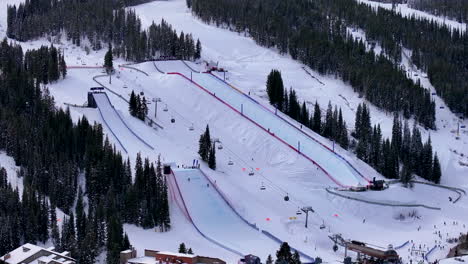 Half-Pipe-Big-Air-Jump-ski-snowboard-gondola-ski-lift-aerial-drone-cinematic-Copper-Mountain-Colorado-Winter-December-Christmas-Ski-runs-trails-landscape-Vail-cloudy-Rocky-Mountains-circle-right