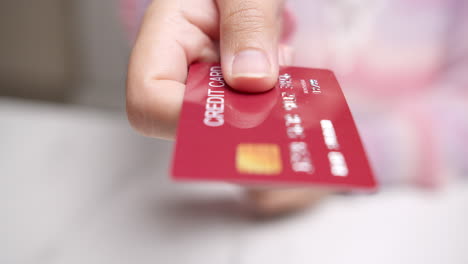 Detail-of-female-hands-selecting-credit-card-to-make-purchase
