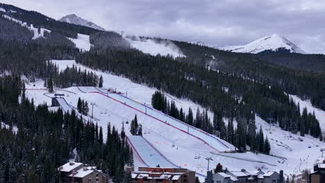 Snow-making-Half-Pipe-Big-Air-Jump-ski-snowboard-gondola-ski-lift-aerial-drone-cinematic-Copper-Mountain-base-Colorado-Winter-December-Christmas-Ski-runs-trails-landscape-Rocky-Mountains-circle-left